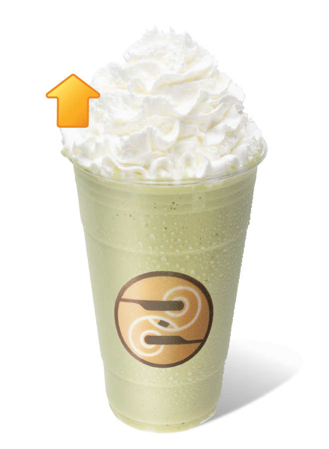 Ziggi's Coffee Frozen Protein Matcha Blender in a clear cup with a pale green blend topped with whipped cream