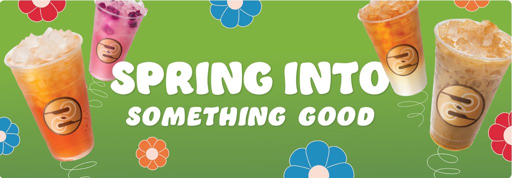 Green banner graphic with colorful flower illustrations and four Ziggi’s iced drinks displayed across the image. The drinks include a bright orange iced beverage, a pink iced fruit drink with berries, a layered iced tea with cream, and a cinnamon-topped iced coffee, each in clear cups with the Ziggi’s logo. Large white headline text in the center reads: “SPRING INTO SOMETHING GOOD.”