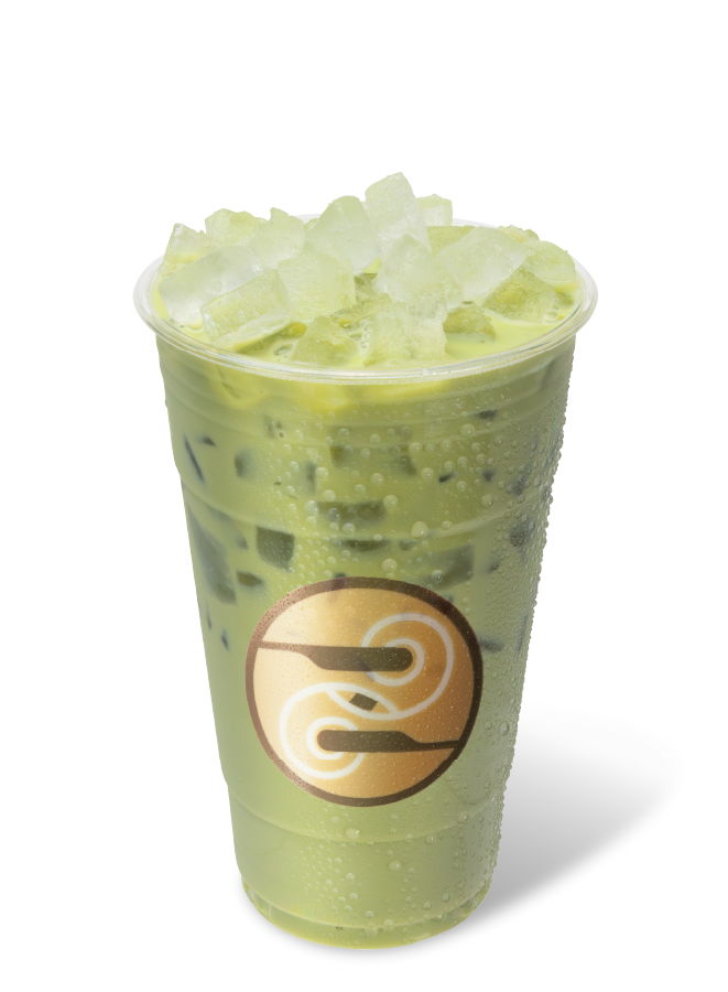 Iced cherry almond matcha latte with ice in a clear Ziggi’s cup.