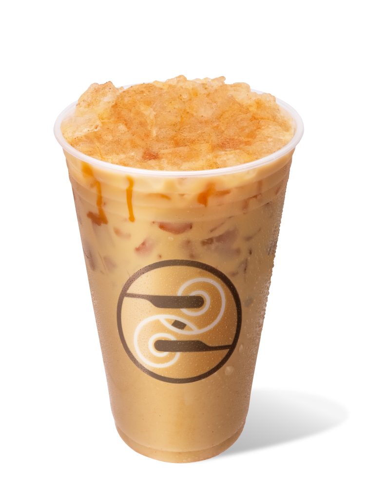 Iced pumpkin drink in a Ziggi's cup with pumpkin drizzle, topped with crushed ice and cinnamon.