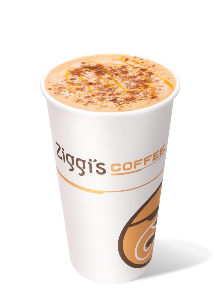 Hot pumpkin latte in a Ziggi's Coffee cup, topped with pumpkin drizzle and cinnamon.