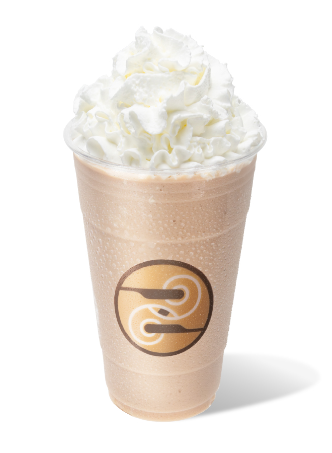 Blended Banana Bread Chai topped with whipped cream, in a Ziggi's logo cup, on a white background.